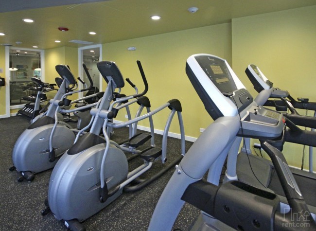 a gym with several pieces of exercise equipment